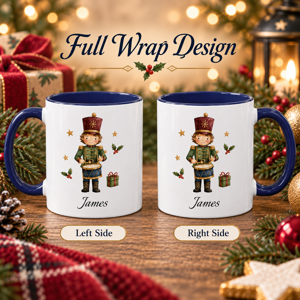 Two white ceramic mugs with dark blue interiors and handles are shown side by side on a wooden surface with Christmas decorations and warm blurred lights in the background. The mugs feature a printed nutcracker illustration and the text 'Full Wrap Design,' 'James,' 'Left Side,' and 'Right Side.