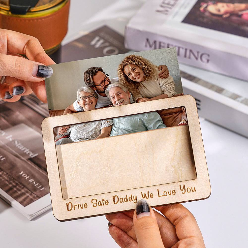 Personalized MadeMine car sun visor clip with magnetic photo frame accessory, holding a custom photo in a vehicle interior.