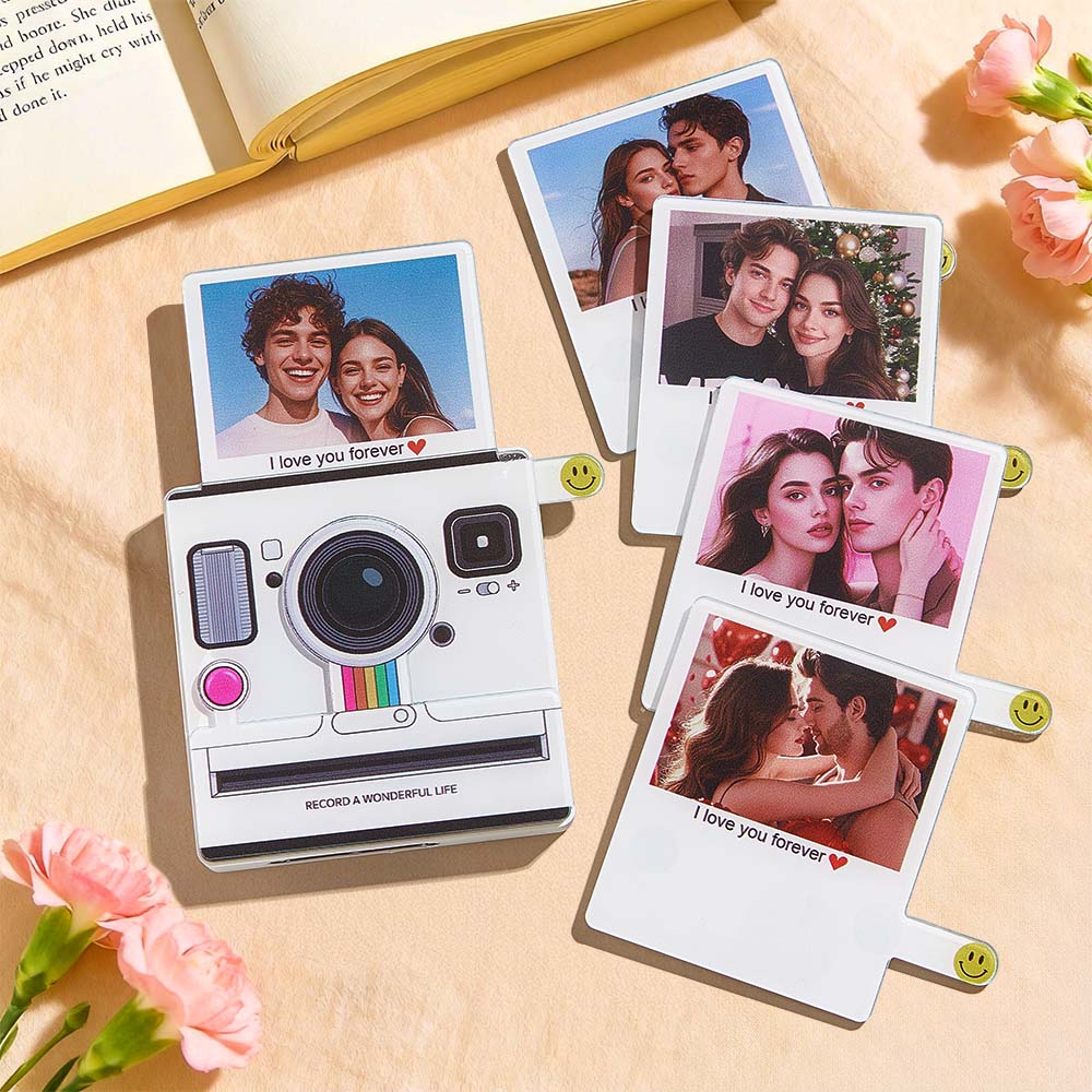 Fotografie camera with printed photos on a wooden surface