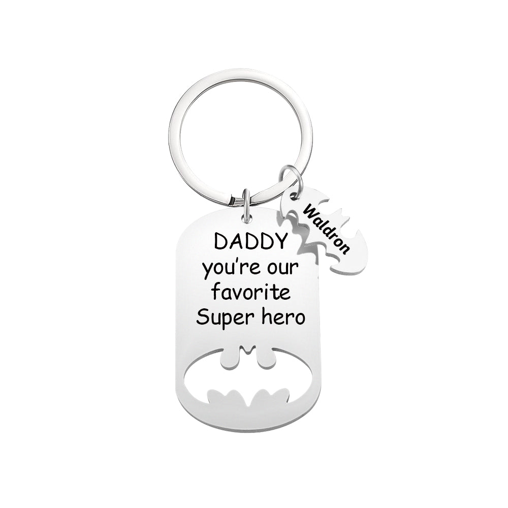 Keychain with 'Daddy, you're our favorite Super hero' text and Batman logo on a white background