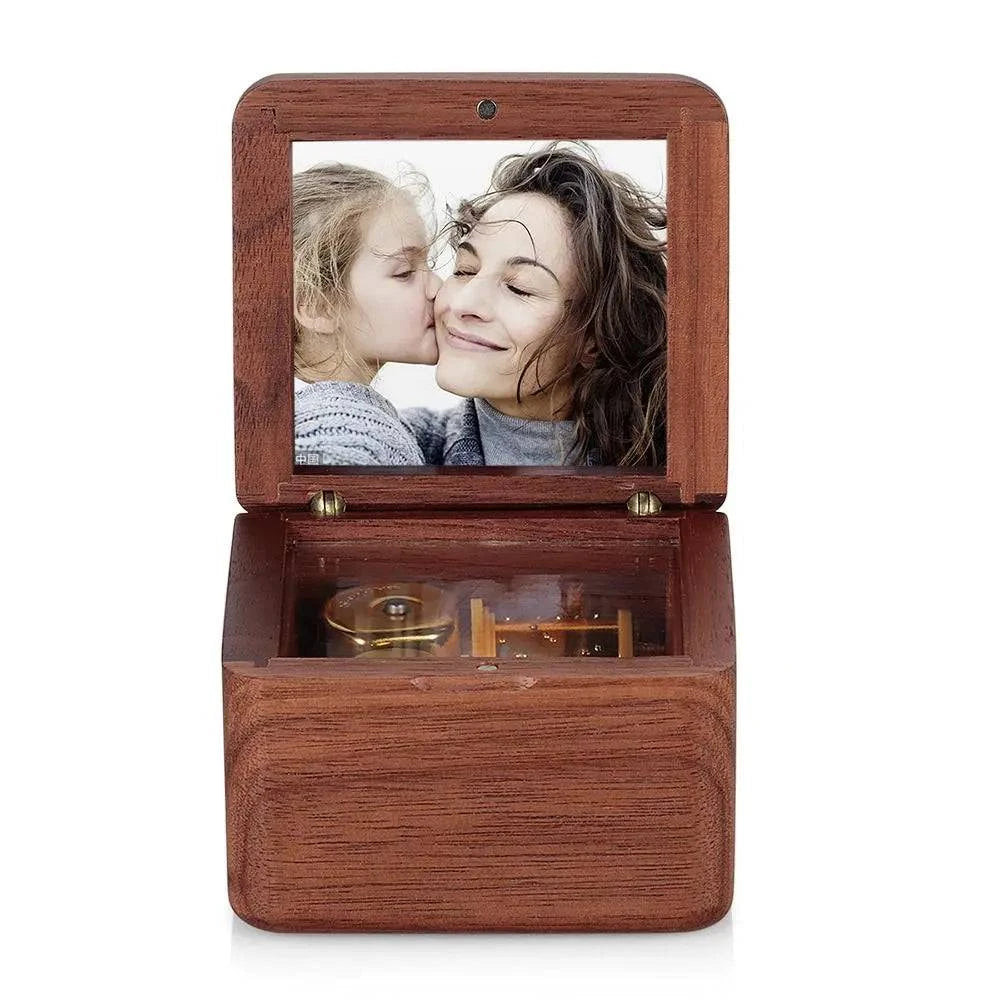 Personalized wooden photo music box by MadeMine featuring a vintage romantic design with a photo frame and intricate wood detailing.