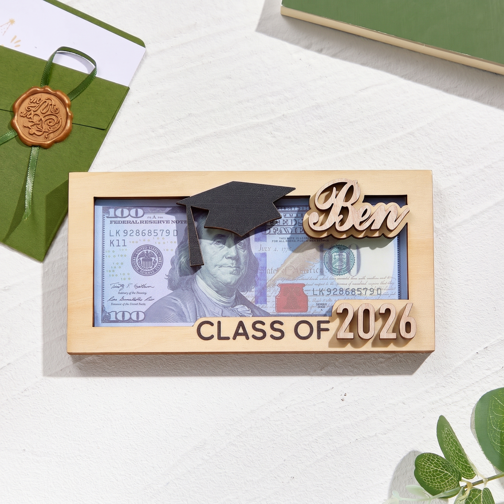 Graduation-themed wooden frame with 'Ben' and 'Class of 2026' text, featuring a dollar bill inside.