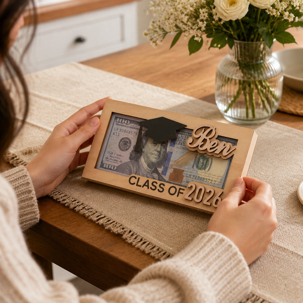 Personalized Graduation Wooden Money Box · Hands Interacting with Money Box at Table